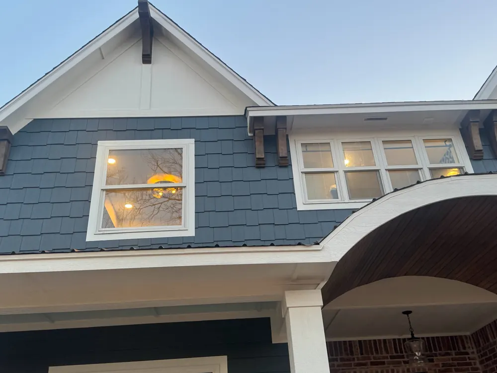 deep navy painted shake siding with crisp white exterior trim on a custom home