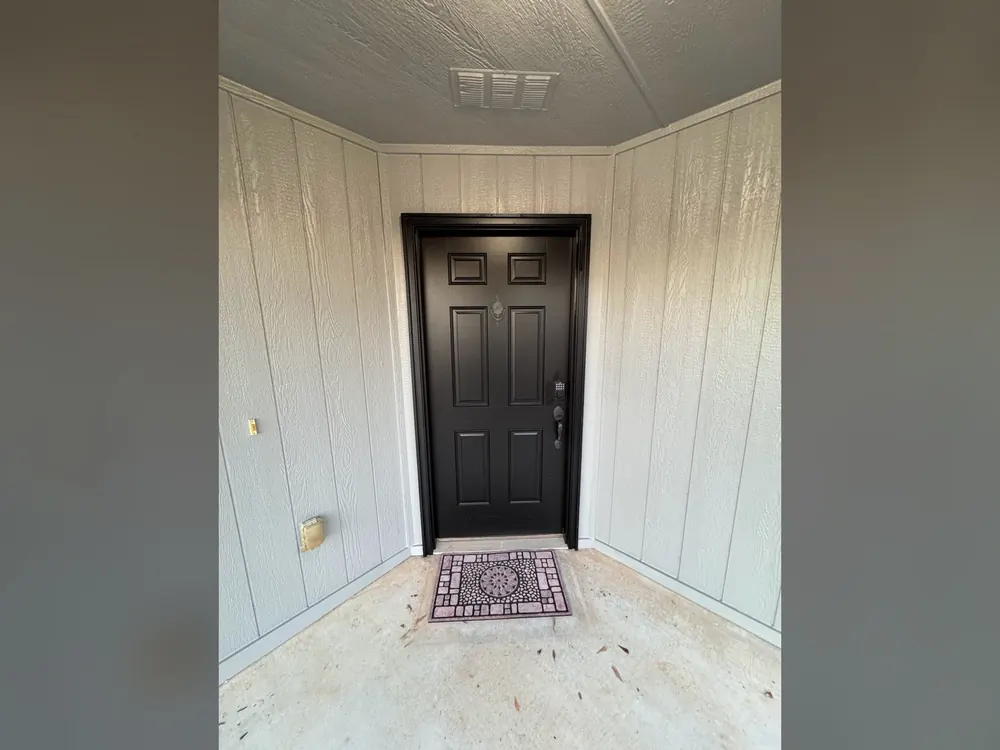 finished black exterior entry door with painted white trim