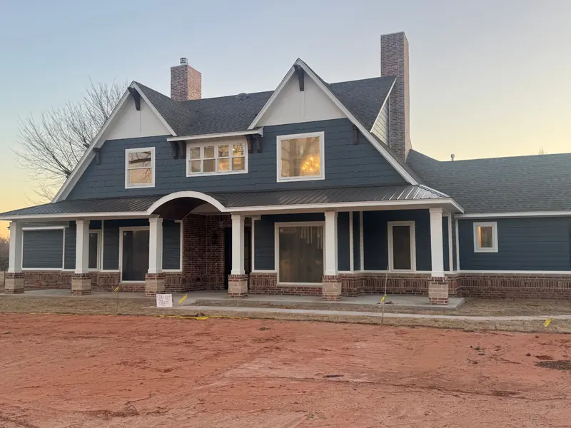 exterior painting contractor in Moore OK navy siding and white trim on a custom home
